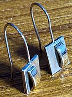 Side angle of both earrings showing French hooks and gold accent curve