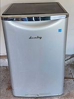 Front view of Danby stainless-look mini fridge showing exterior finish and logo