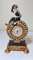 Front view of jester mantel clock showing overall design and dial