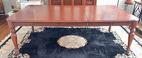 Full view of tabletop, apron carvings and legs