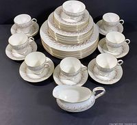 Full set stacked showing plates, cups, saucers, creamer