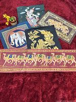 Group shot of all five satin prints on red background