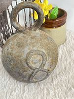 Front view showing full spherical weight, loop handle, embossed 8