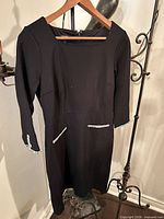 Front view of black dress on hanger