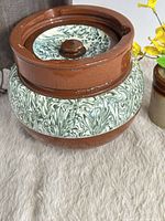 Full view of brown ceramic tobacco jar with marbled band and lid