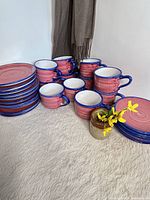 Group view of Vietri ceramic bread plates, cups and saucer