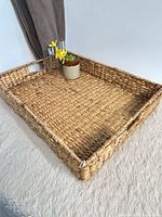 Top angle of rectangular seagrass tray showing interior weave and one handle cut-out