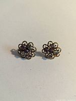 both earrings front view showing overall floral design and stone colors