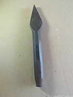 Full view of antique hand forged cape chisel showing point, shank and patina