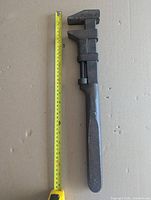 Full view wrench beside tape showing 18" length