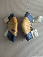 Pair of elbow pads top view showing exterior leather and detached elastic