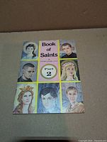 Front cover of Book of Saints Part 2 showing title, author, series, and saint portraits