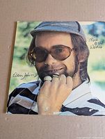 Front album cover with Elton John portrait