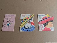 Fronts of three of the four vintage Easter cards laid out