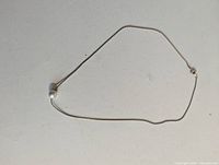 Full view of gold tone chain necklace with single faux pearl bead