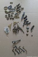 overall view of assorted antique hardware spread on cardboard