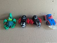 Front view of Scorpion Stingstriker, two Venom Webrunners, Spiderman car with web projectile