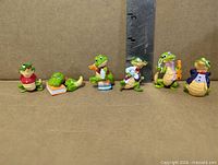 Group of six Kinder Surprise Crazy Crocos figurines in various outfits