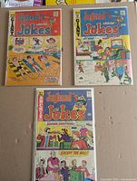 Three Jughead's Jokes comics laid out, shows issue numbers 30, 33, 43 in bags