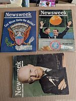 Three Newsweek magazines laid out showing covers