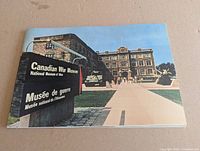 Front cover of smaller booklet showing museum entrance sign and building