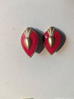 front view showing red enamel leaf design and gold accents
