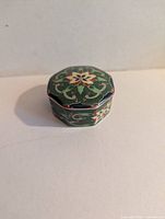 Overall view of the octagonal ceramic trinket box with lid in place showing decorative pattern