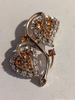 Front view showing amber and clear rhinestones and double heart design