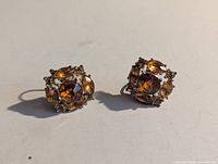 Front view showing amber-colored faceted glass stones and gold-tone setting