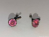 Front view showing pink faceted stones and screw back mechanism