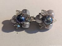 Front view showing faux pearl centres, shell petals and crystal beads