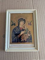 Frontal view of framed miniature religious print