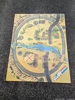 Full view of unfolded cardboard play mat showing printed landscape and GI Joe logo