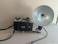 Rear view of Kodak Tourist camera folded with flash attachment mounted