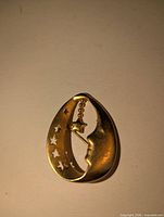 Front view showing moon, star cutouts and dangling charm