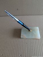 marble desk pen holder side view with pen inserted