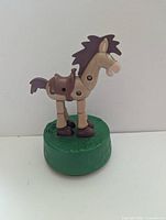 Front left view of Bullseye push puppet on green base