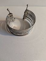 Front view of layered cuff showing textured central band and overall design