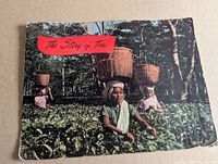 Front cover of The Story of Tea booklet showing tea pickers in field