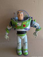 Front view of Buzz Lightyear figure showing missing visor half and sticker wear