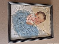 Front view of framed baby lithograph collage