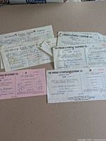 Five telephone company receipts in assorted colors with handwriting