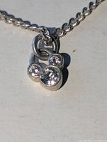 Close-up of Mickey Mouse rhinestone pendant on silver-tone chain