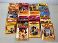 Overview of sixteen German pulp paperbacks laid out in four rows