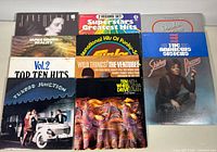 Group shot of nine visible album fronts