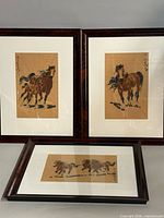 Group shot of three framed horse paintings