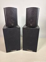 All four speakers, two small atop two large