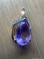 Front view showing amethyst, gold setting, diamond accents