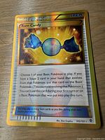 Front view of Rare Candy Secret Rare card 105/101 showing artwork, gold border and holographic foil