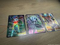 All three cards laid out side by side on tabletop